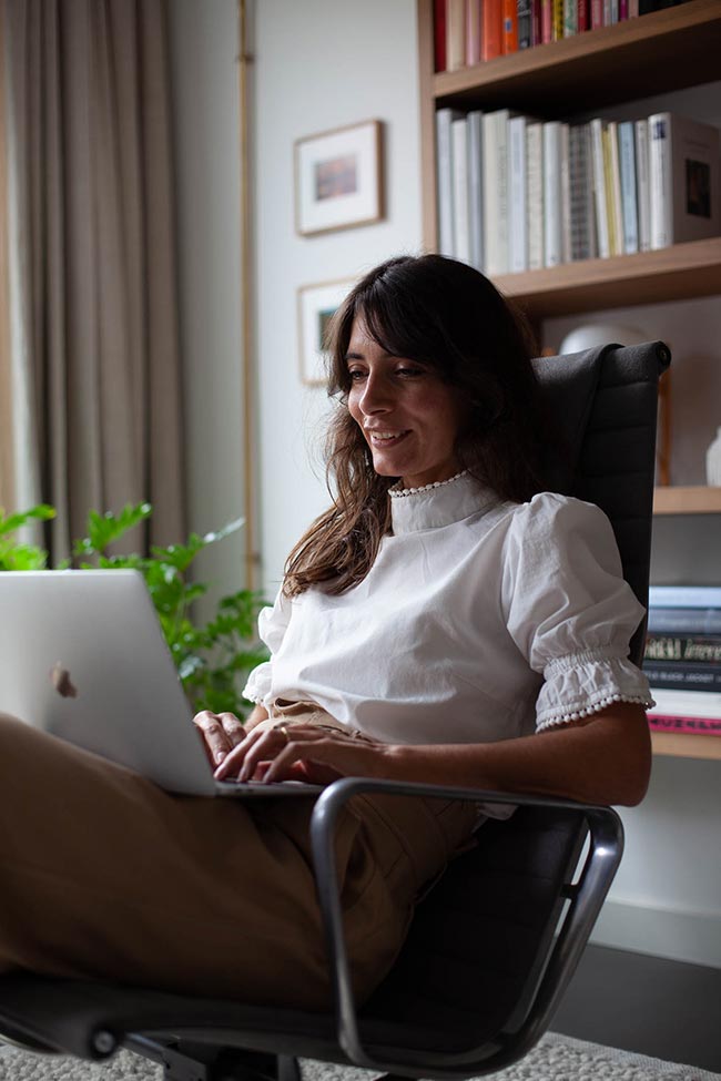 Daphne Maierna working at her laptop